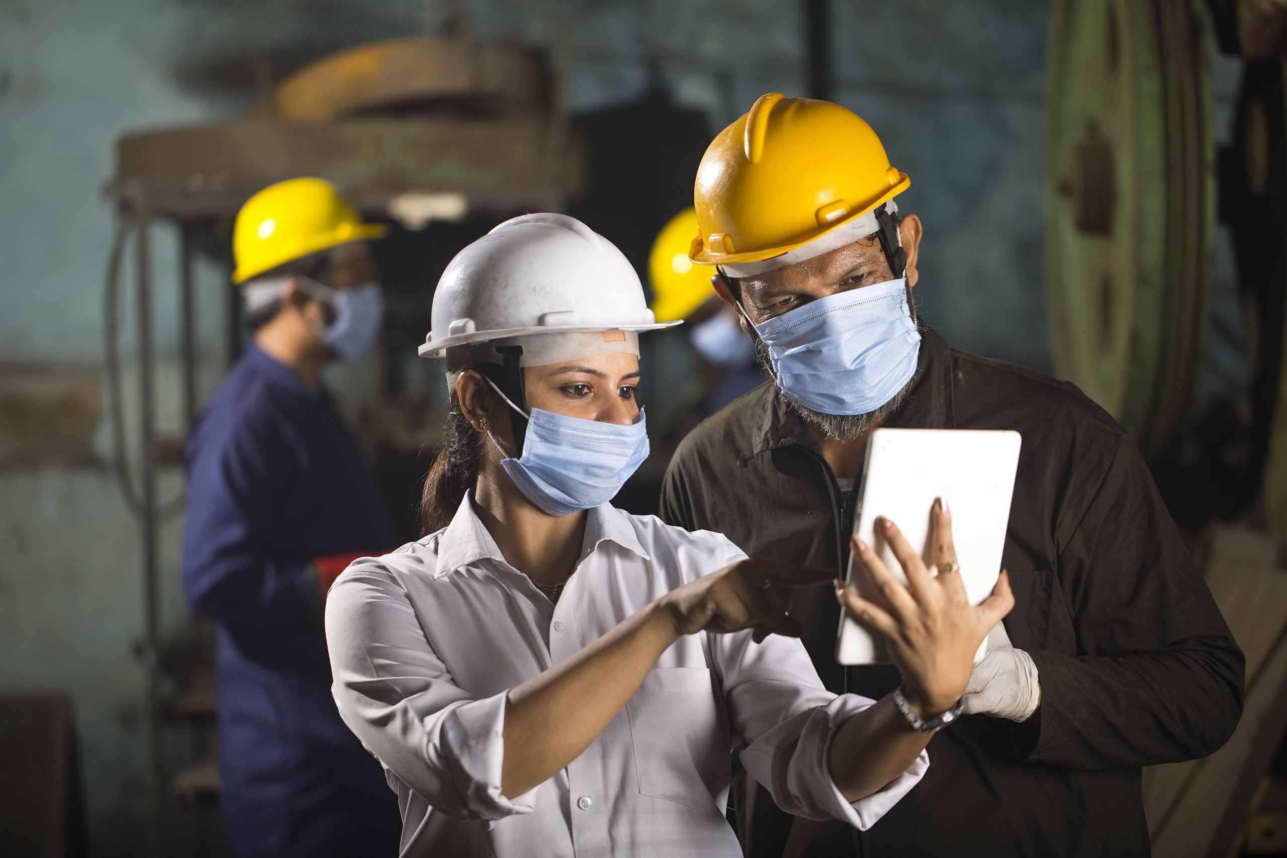 Business colleagues using digital tablet at factory