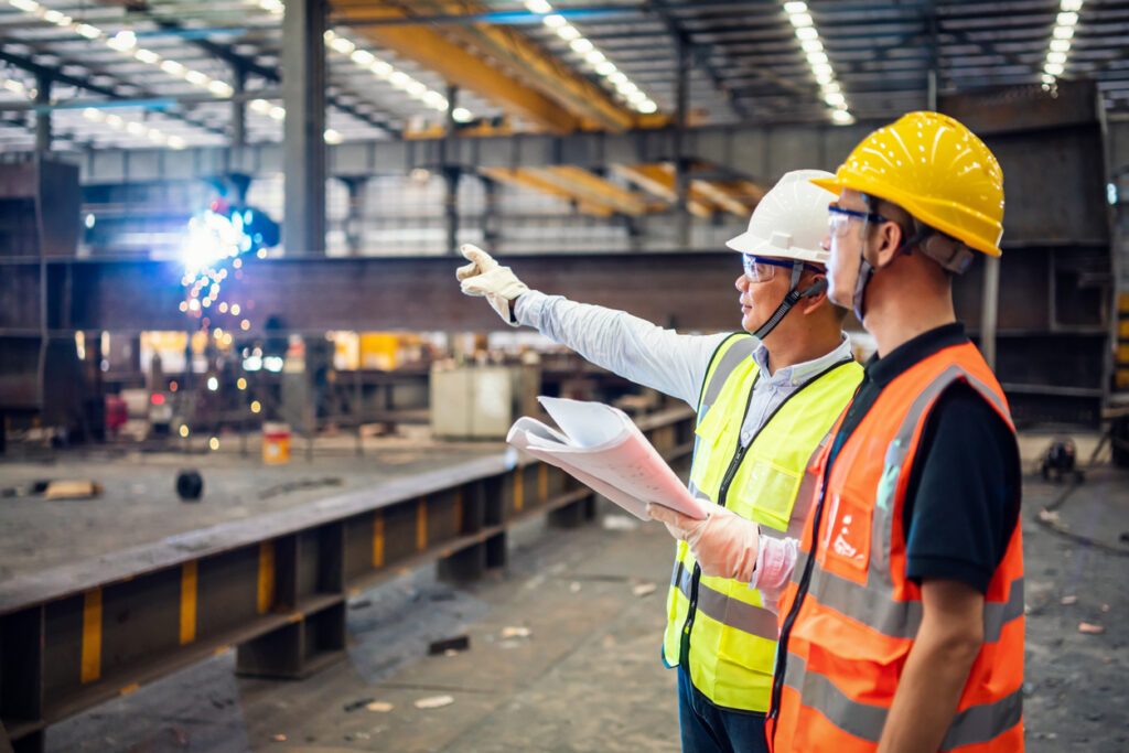 Quality inspectors working in a steel factory